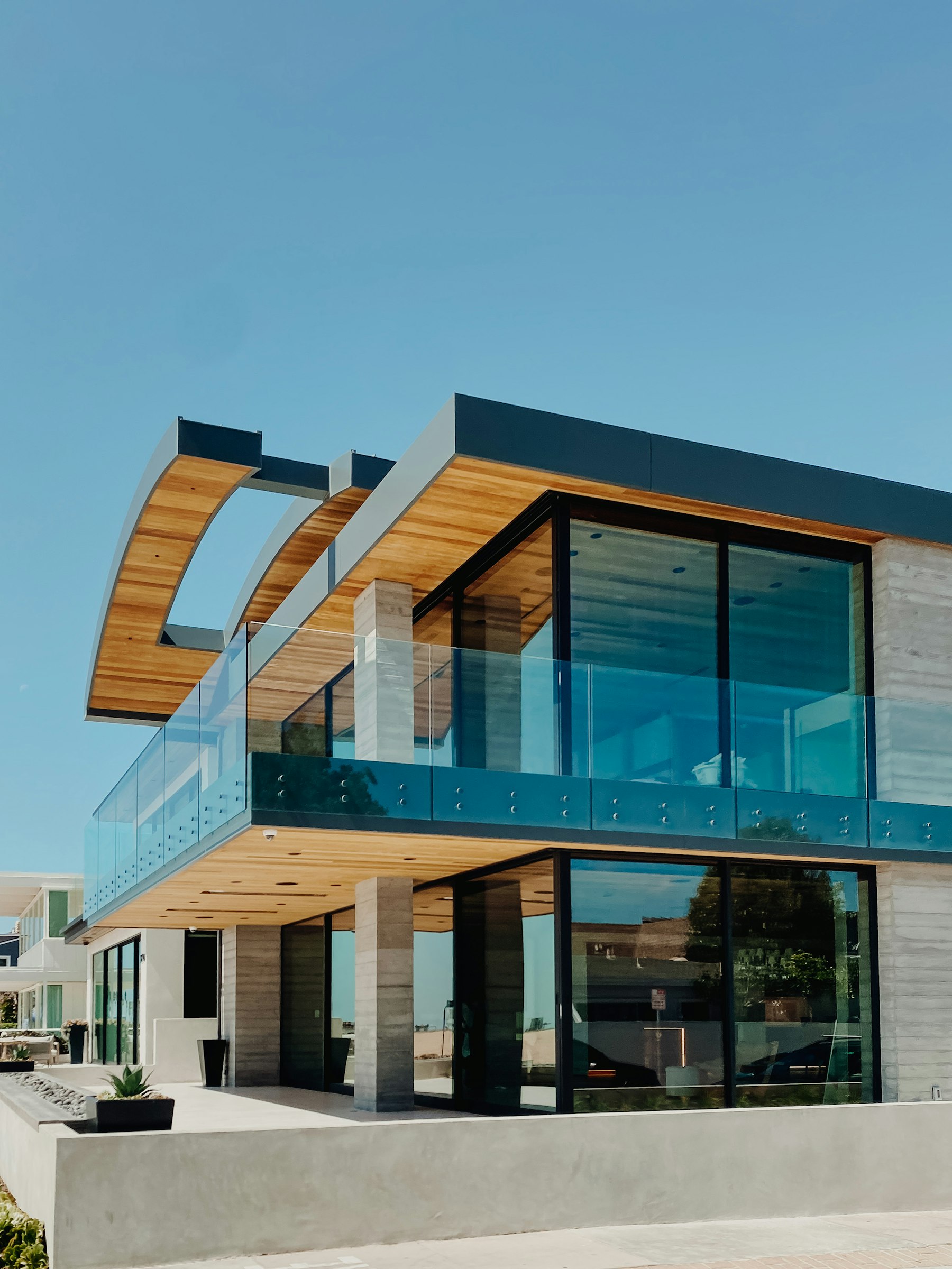 Contemporary residential architecture with expansive glass and a curved roof